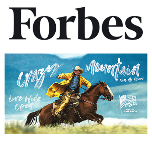 Cowboy galloping on a horse across a grassy plain with overlaid text ‘Crazy Mountain Non-Ale Brew’, ‘Live Wide Open’, and a Made in America flag