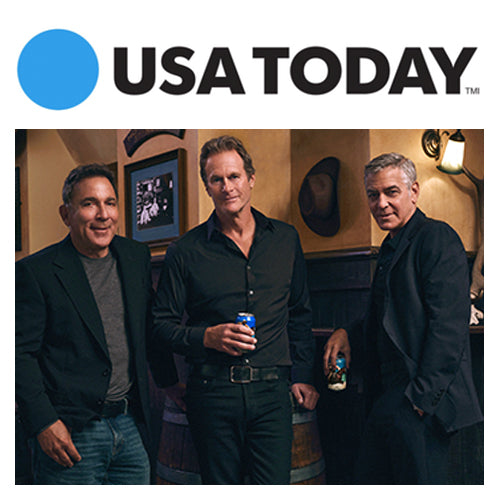 Three men holding drinks in a dim bar beneath a USA TODAY logo
